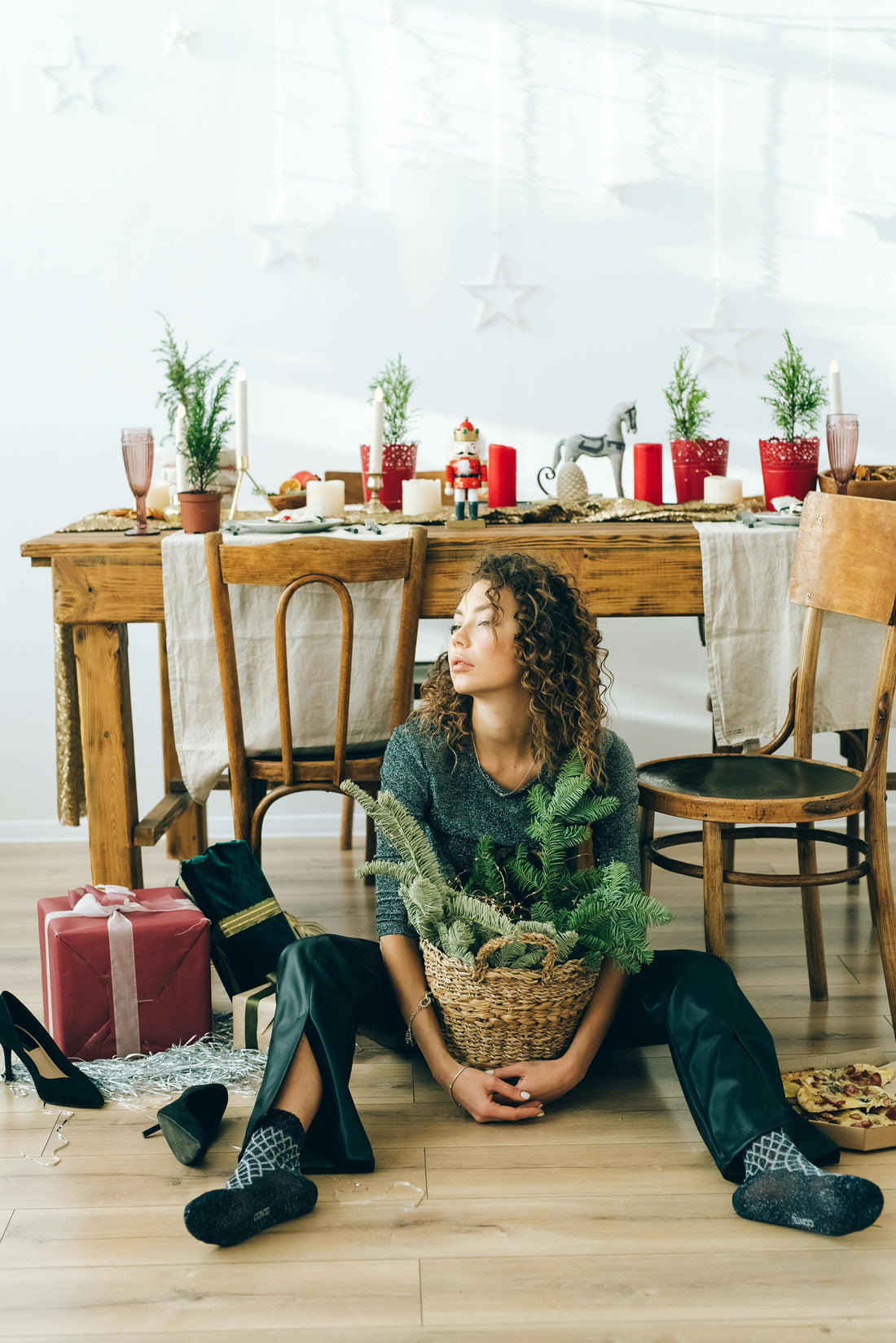 girl sitting on floor with holiday table scene looking depressed