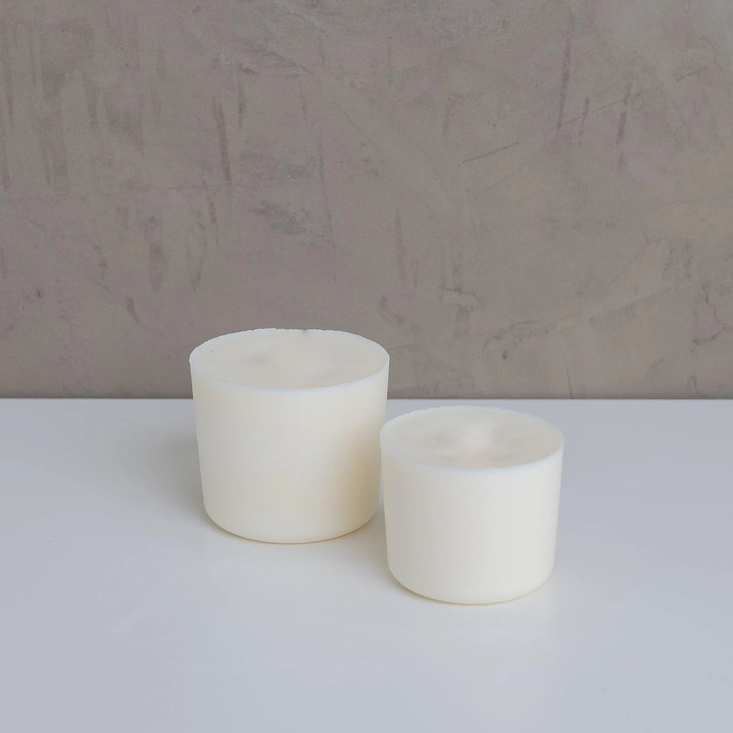 flat lay image with two size of candle refills on neutral background