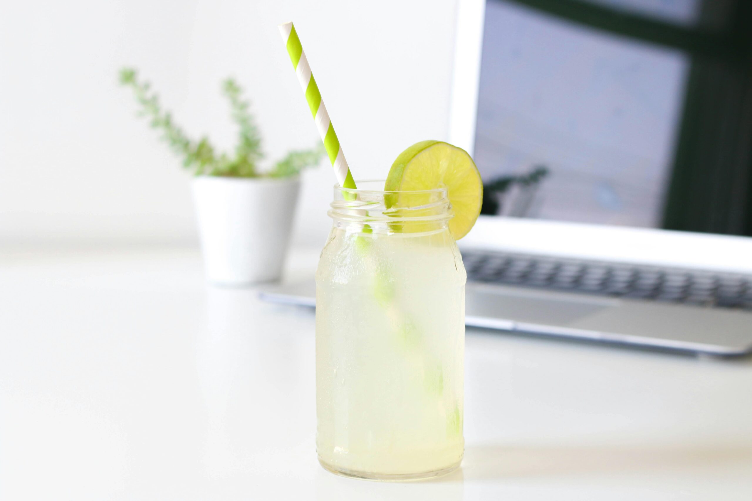 glass of lemonade in front of laptop