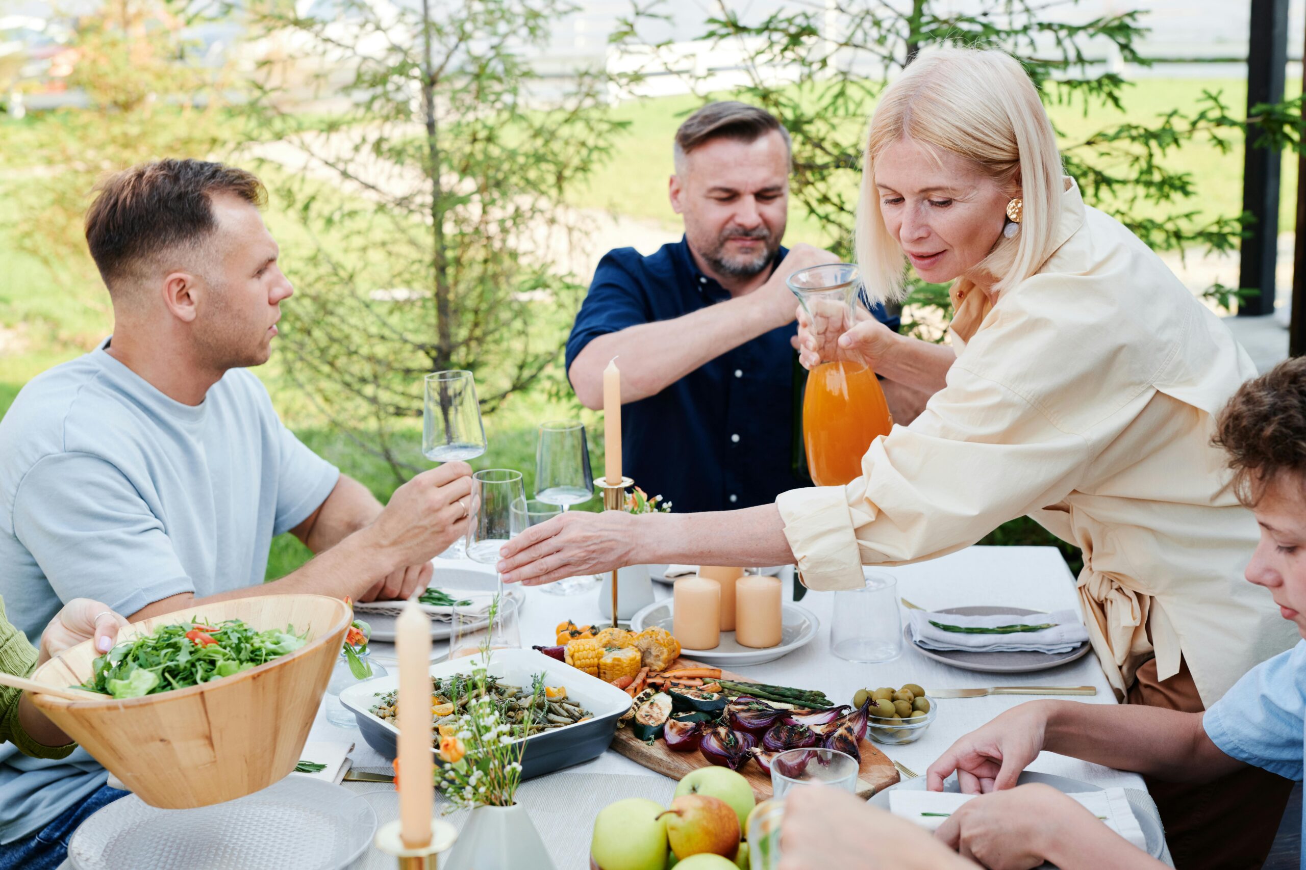 group of people eating together outdoors enjoying life together