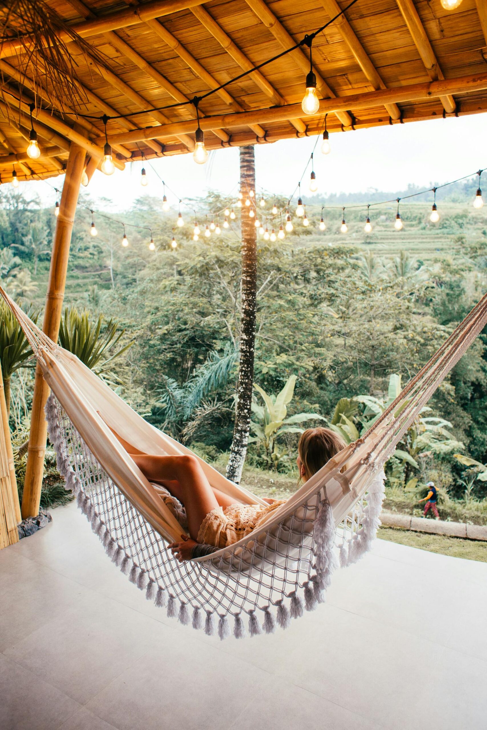woman laying in hammock in jungle